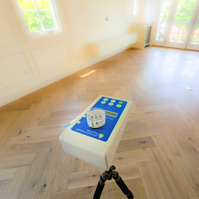 Air Sampling. Professional air sampling pump and cassette trapping mold spores in a residential living space for laboratory analysis.