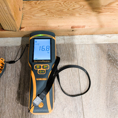 Moisture Content (MC) testing during post remediation verification (PRV). Tanjun Mold Inspections inspector performing Moisture testing.