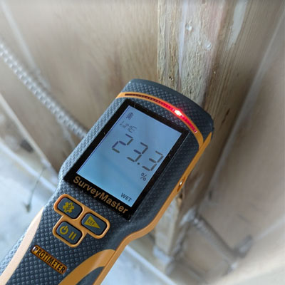 Professional pin-type digital moisture meter used for detecting water leaks and hidden moisture in building materials.
